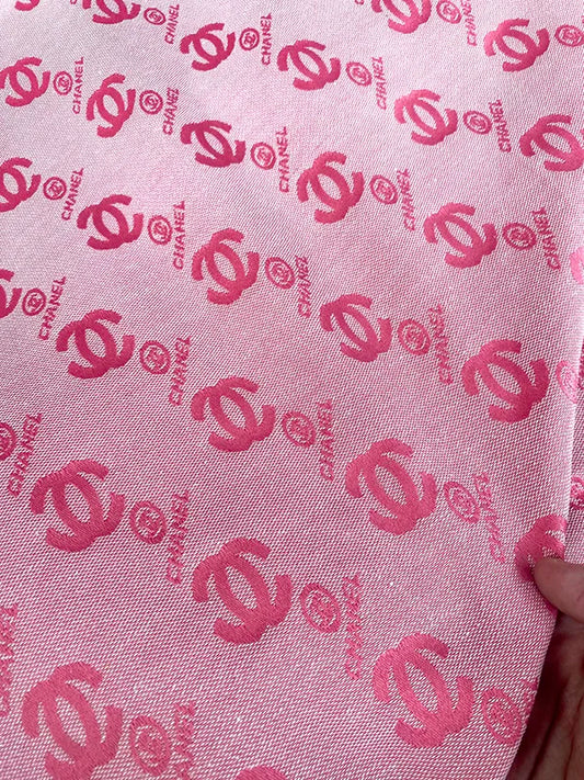 Pink fabric with red Chanel logo pattern