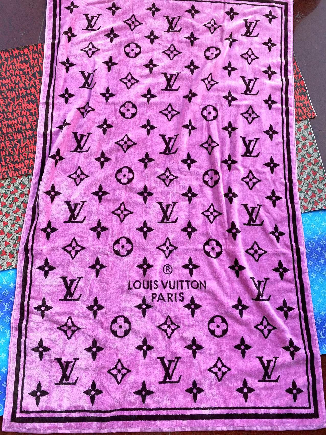 Pink Louis Vuitton beach towel with black monogram pattern